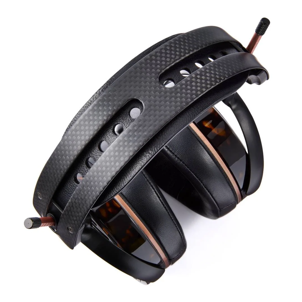 Black over-ear headphones with a carbon fiber texture on a white background