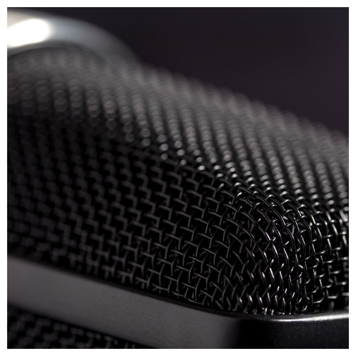 Close-up of a textured black surface with a blurred background