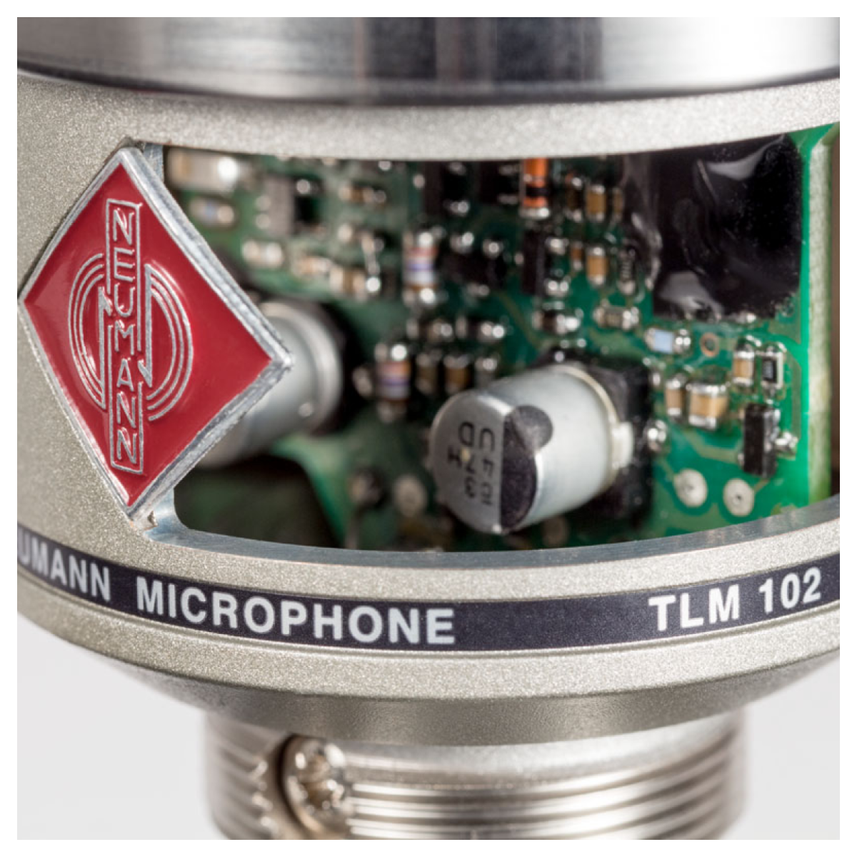 Close-up of a Neumann microphone with visible branding and components.