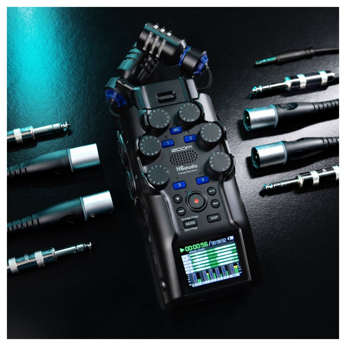 Digital audio recorder with various attachments on a dark surface